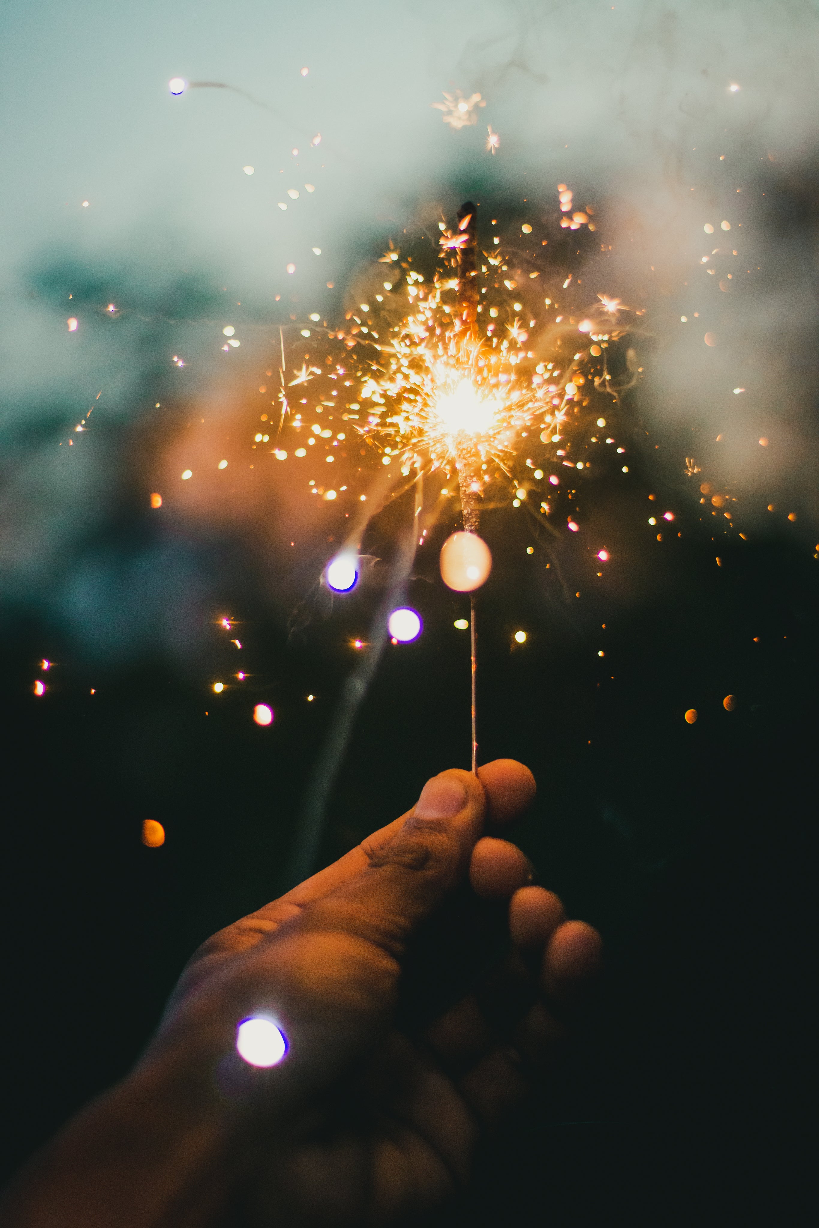 hand-holds-up-brightly-lit-sparkler.jpg